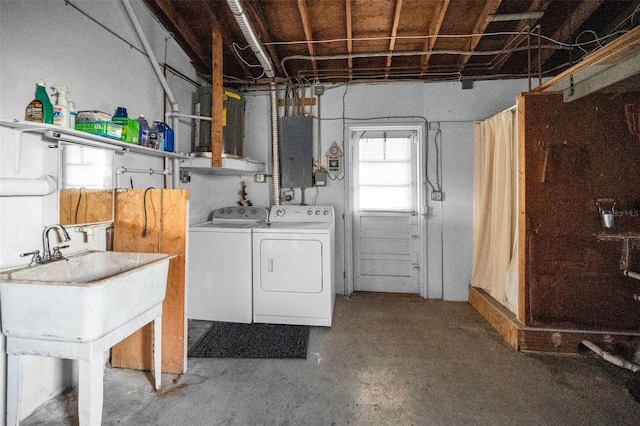 washroom featuring laundry area, electric panel, and washer and clothes dryer