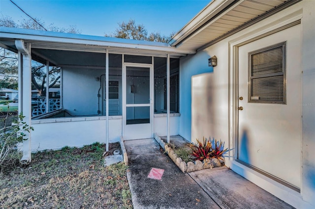 property entrance with stucco siding