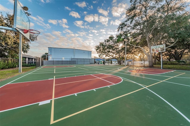 view of basketball court with community basketball court and fence