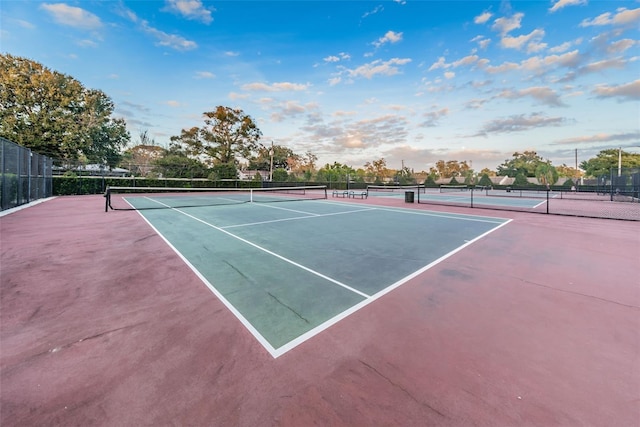 view of sport court featuring fence