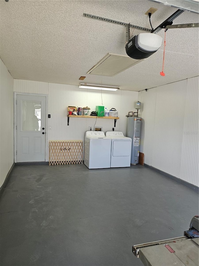 garage featuring a garage door opener, electric water heater, and independent washer and dryer