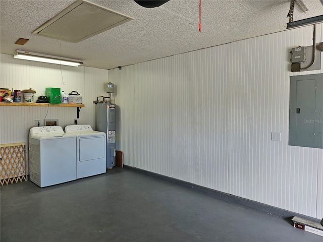 interior space with laundry area, electric panel, electric water heater, washing machine and clothes dryer, and a textured ceiling