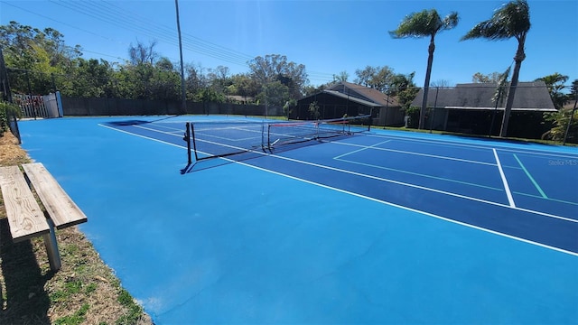 view of sport court with fence