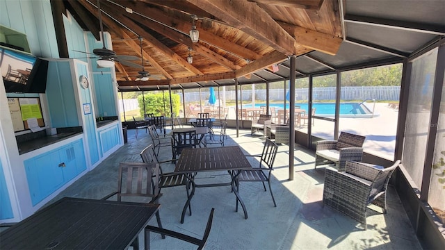 view of patio / terrace with ceiling fan, fence, and a community pool