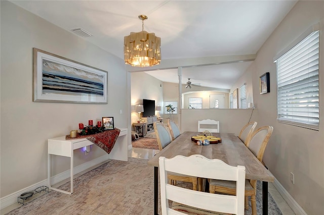 dining space with visible vents, vaulted ceiling, baseboards, and ceiling fan with notable chandelier