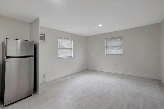 empty room featuring recessed lighting and baseboards