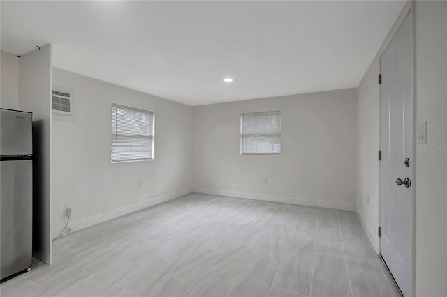 spare room with baseboards and recessed lighting