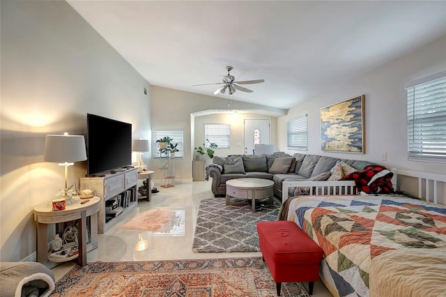 living area featuring vaulted ceiling, ceiling fan, and light tile patterned floors