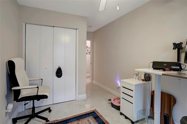 office space with marble finish floor and baseboards