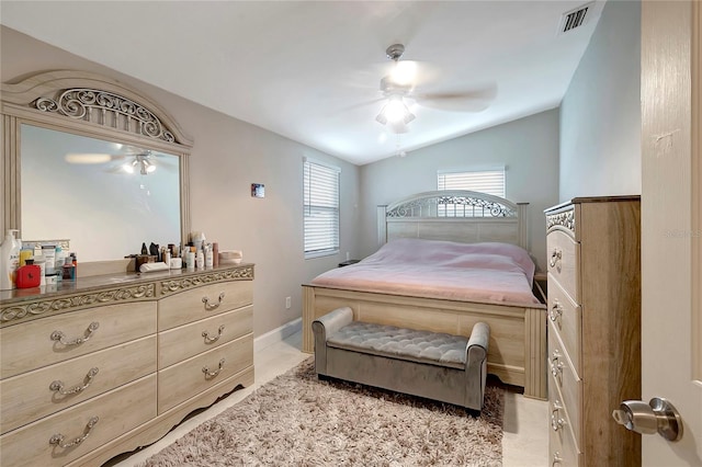 bedroom featuring baseboards, visible vents, a ceiling fan, lofted ceiling, and tile patterned floors