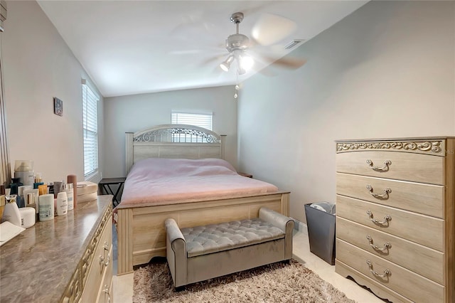 bedroom with lofted ceiling, visible vents, a ceiling fan, and light colored carpet