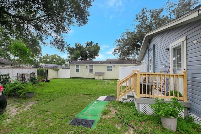 view of yard with a fenced backyard and a wooden deck