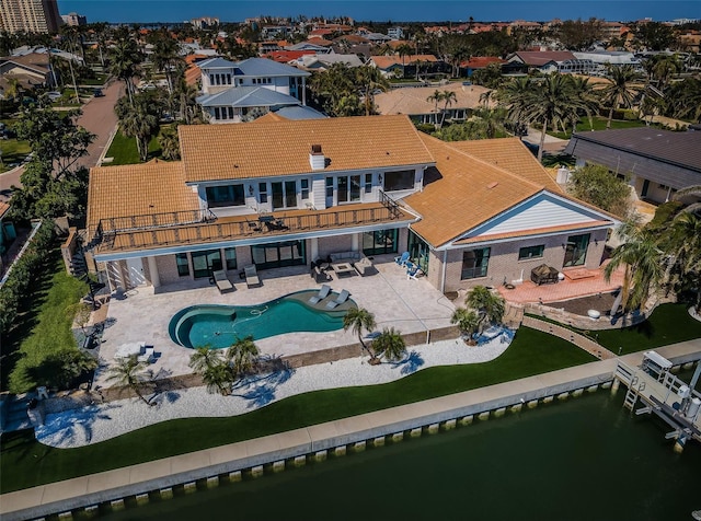 drone / aerial view featuring a water view and a residential view