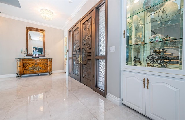 entryway featuring baseboards, crown molding, and french doors