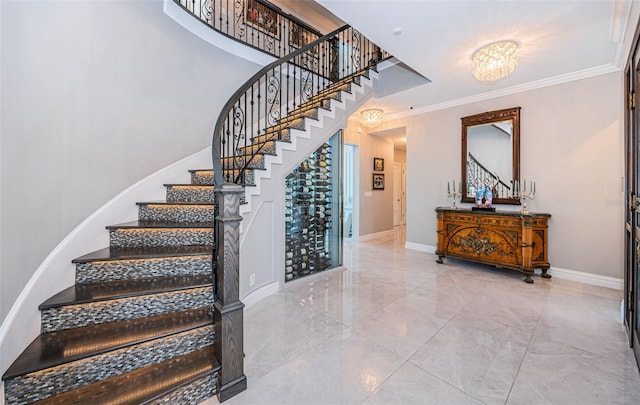 staircase featuring marble finish floor, baseboards, and crown molding