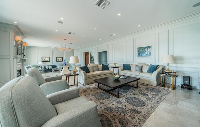 living area featuring crown molding, marble finish floor, visible vents, and a decorative wall