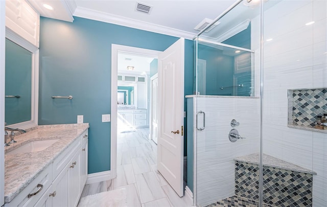 full bath featuring vanity, visible vents, baseboards, ornamental molding, and a stall shower