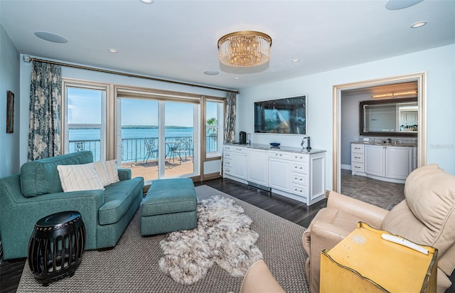 living room with a notable chandelier, baseboards, dark wood-type flooring, and recessed lighting