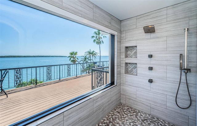 sunroom / solarium with a water view and a wealth of natural light