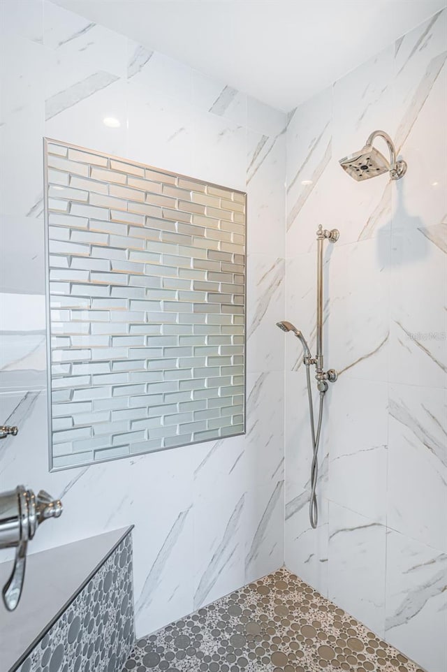 full bathroom with a marble finish shower