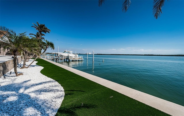 dock area featuring a water view and a yard