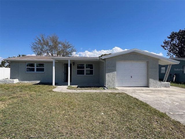 ranch-style home featuring a garage, concrete driveway, and a front lawn