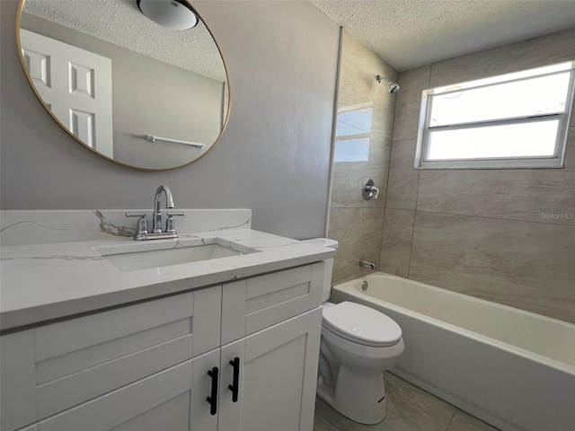 bathroom featuring toilet, washtub / shower combination, a textured ceiling, and vanity