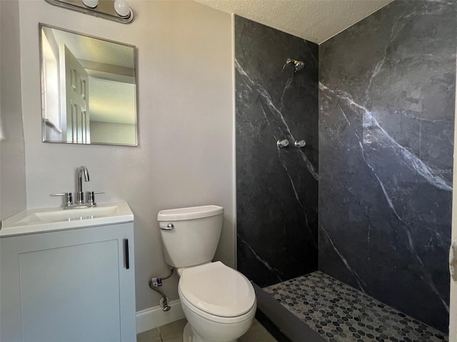 full bath featuring a marble finish shower, baseboards, toilet, a textured ceiling, and vanity