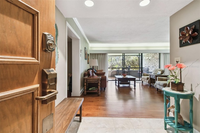 interior space with ornamental molding and light wood-type flooring