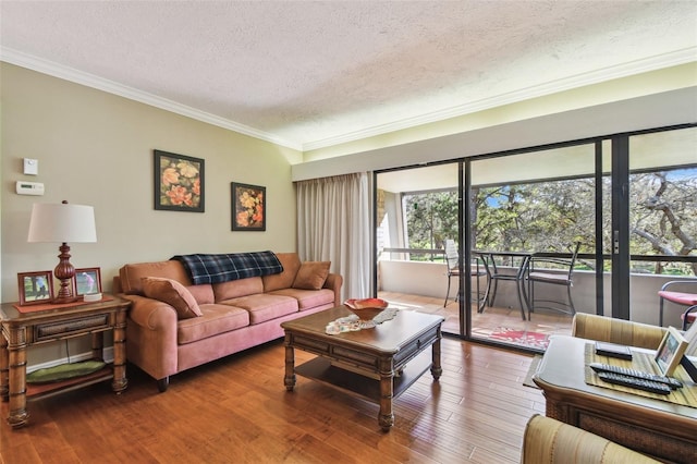 living area featuring a textured ceiling, ornamental molding, and hardwood / wood-style floors