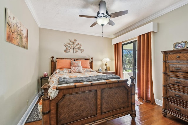 bedroom featuring baseboards, a textured ceiling, wood finished floors, and crown molding