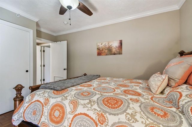 bedroom featuring ornamental molding, a ceiling fan, and wood finished floors