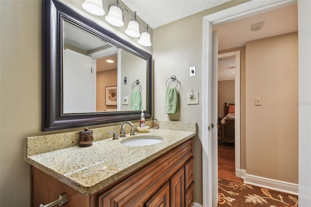 bathroom with vanity and baseboards