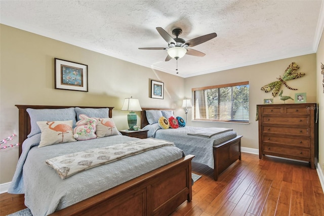 bedroom with crown molding, ceiling fan, a textured ceiling, baseboards, and hardwood / wood-style flooring