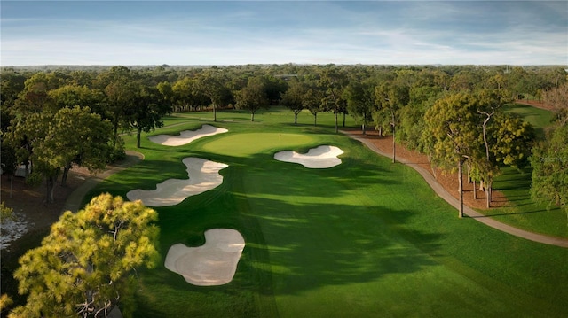 view of home's community featuring view of golf course and a view of trees