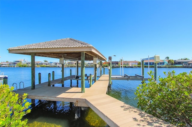 dock area with a water view and boat lift