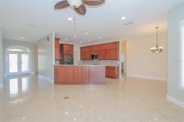 kitchen with tasteful backsplash, visible vents, appliances with stainless steel finishes, a peninsula, and baseboards