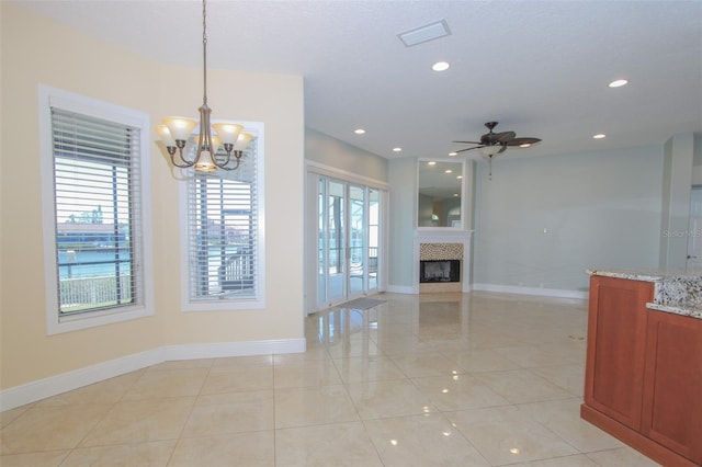 unfurnished living room with recessed lighting, a fireplace, and baseboards