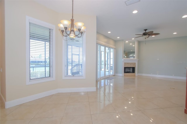 unfurnished living room featuring light tile patterned floors, baseboards, visible vents, and a glass covered fireplace