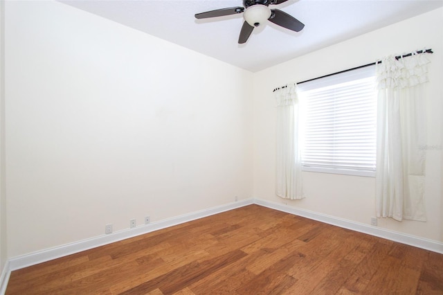 empty room with light wood finished floors, ceiling fan, and baseboards