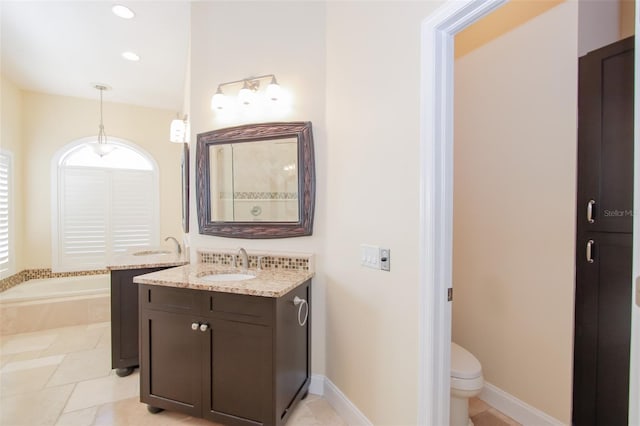 full bath with a garden tub, toilet, recessed lighting, vanity, and baseboards