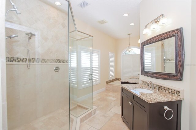 full bath with baseboards, visible vents, a walk in shower, and vanity