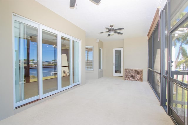 unfurnished sunroom featuring french doors and a ceiling fan