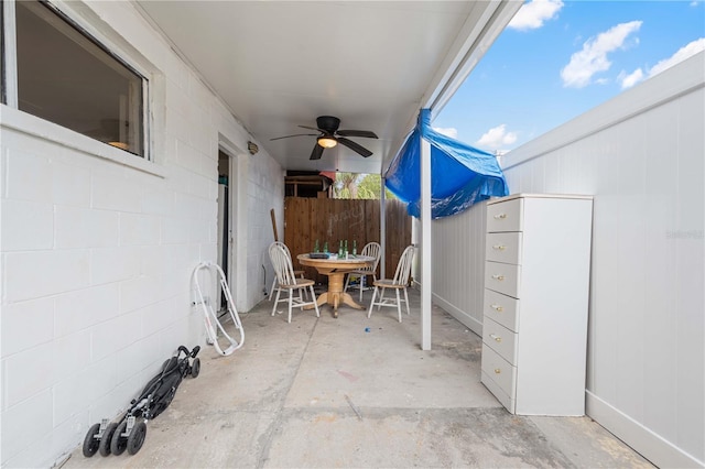 view of patio with ceiling fan and fence