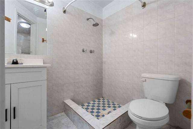 full bath featuring toilet, tile walls, tiled shower, and vanity