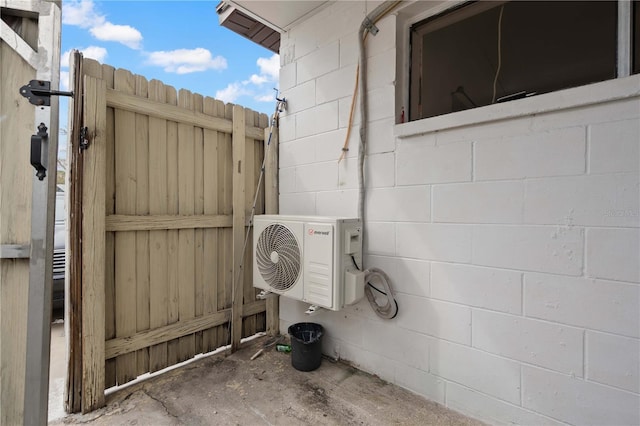 exterior space with ac unit and concrete block siding