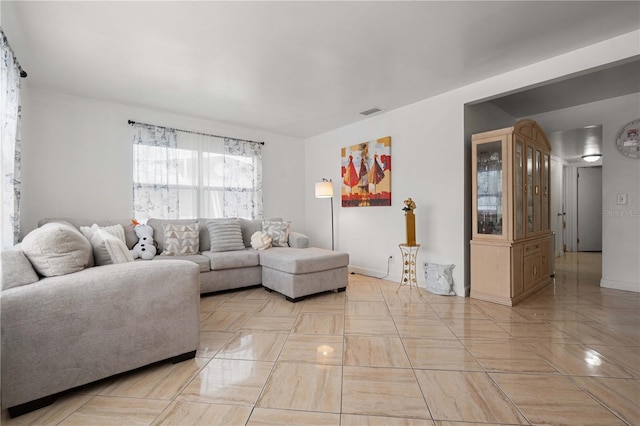 living area with visible vents and baseboards