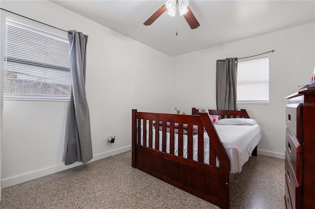 bedroom with a ceiling fan, carpet, and baseboards