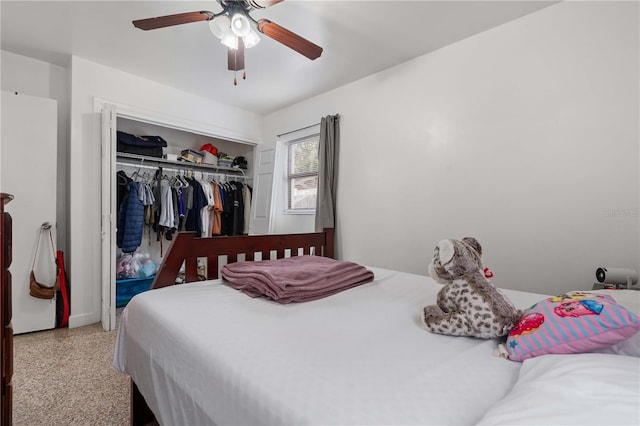 bedroom featuring ceiling fan, a closet, and speckled floor