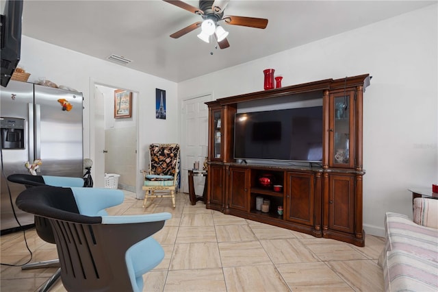 living room featuring a ceiling fan and visible vents